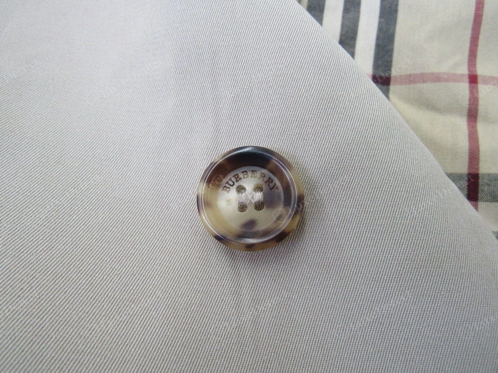 Genuine Burberry trench button — domed horn-look resin, crisp BURBERRY LONDON engraving, shank-sewn tight
